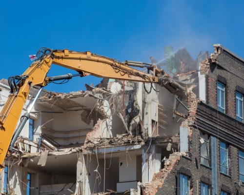 Large,Long,Armed,Demolition,Machine,Seen,Demolishing,A,Building.